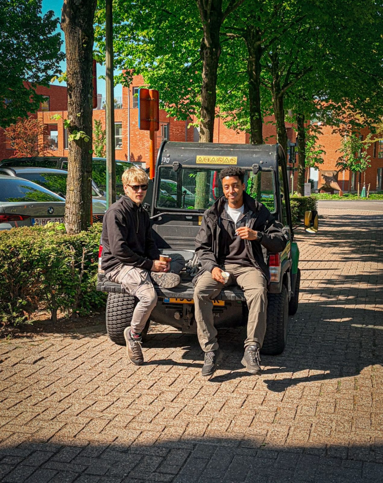 Issam and a colleague sitting on a golf cart