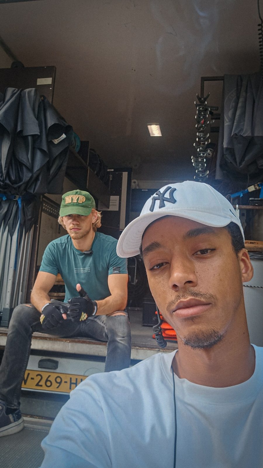 Issam with a colleague by the crew van