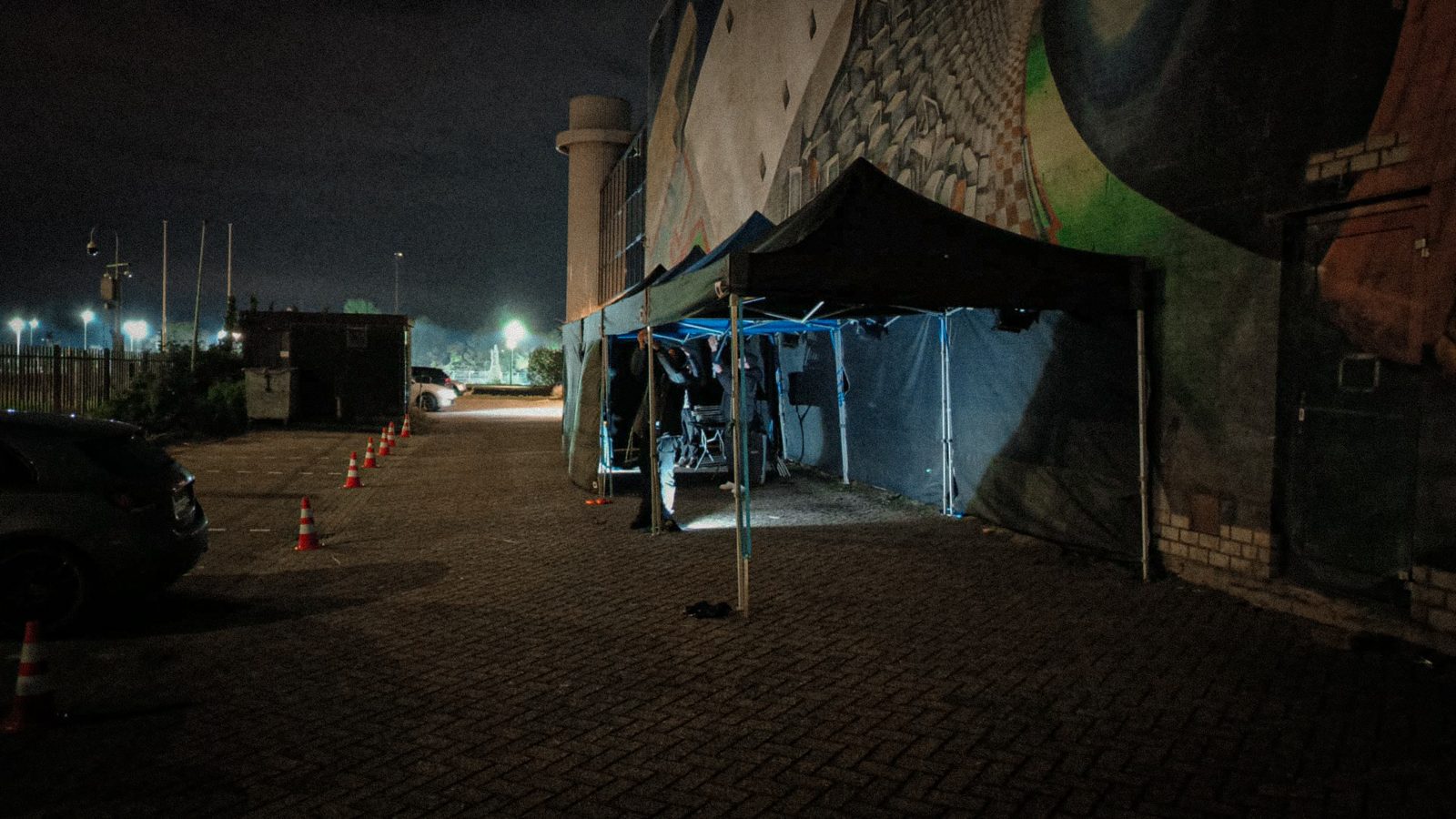 A lit crew tent on location at night
