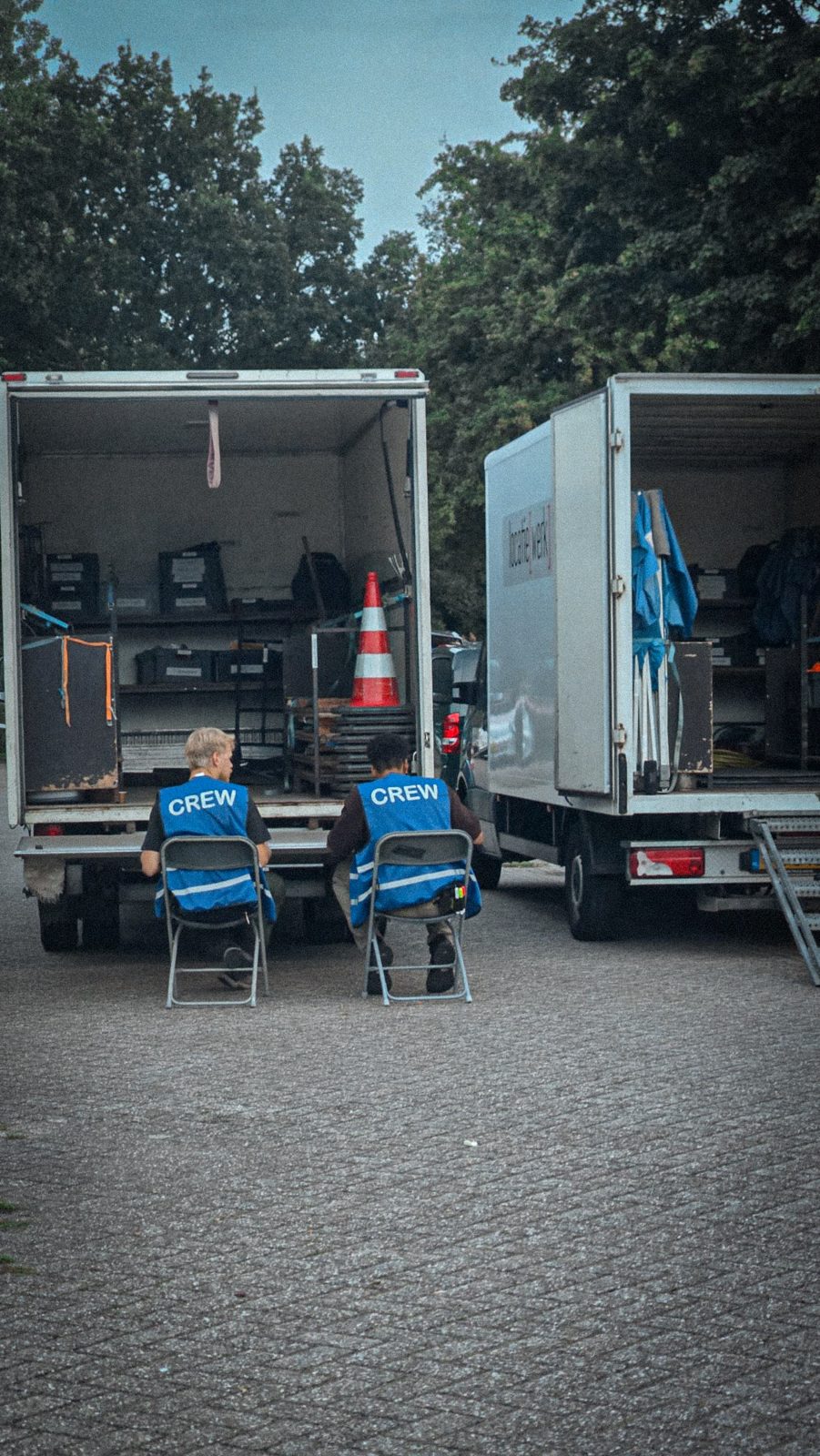 Two crew chairs in front of the open box trucks