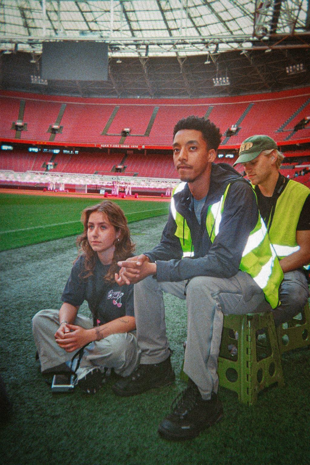 Issam with colleagues on a stadium pitch