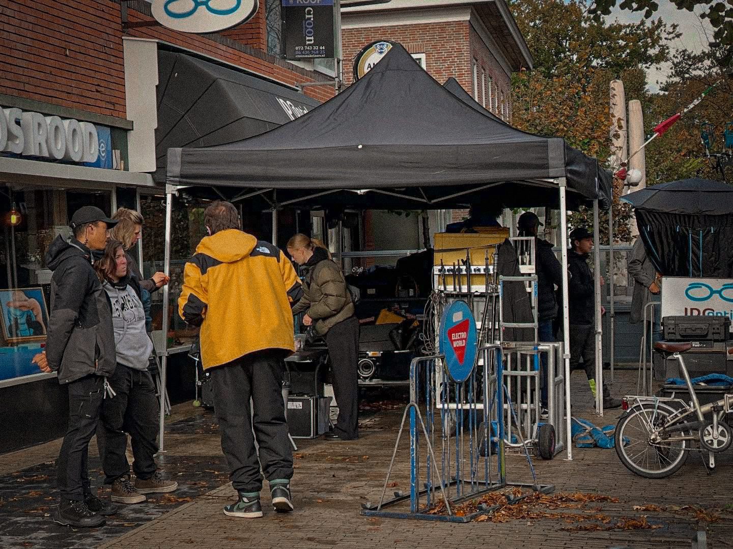 Crew under a gazebo in a shopping street