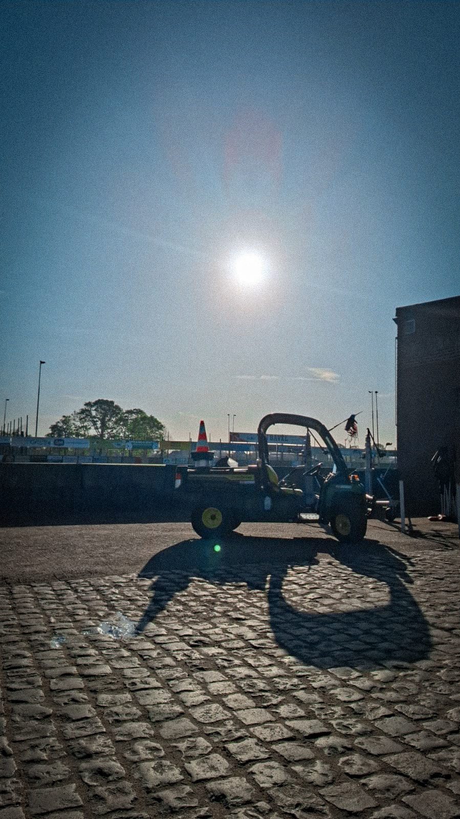 Golf cart in the sun on cobblestones
