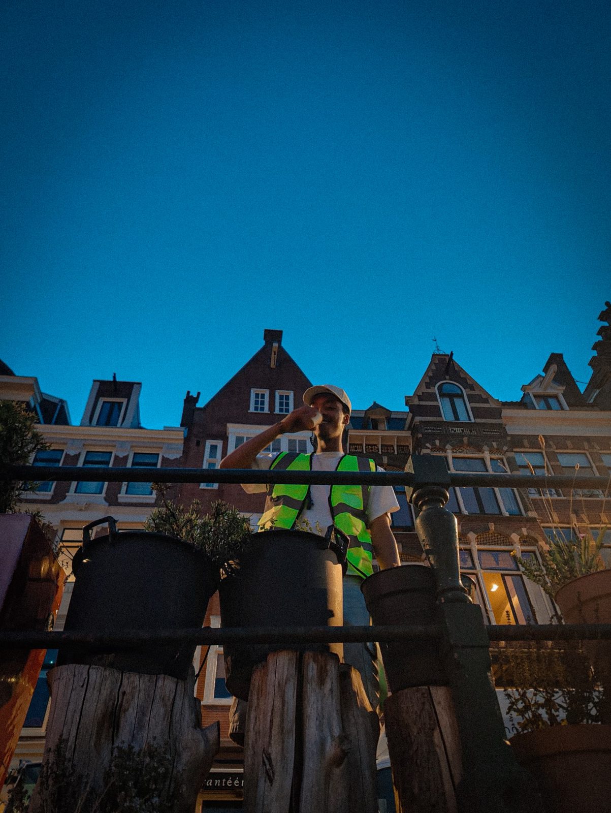 Colleague in a hi-vis vest in front of an Amsterdam facade