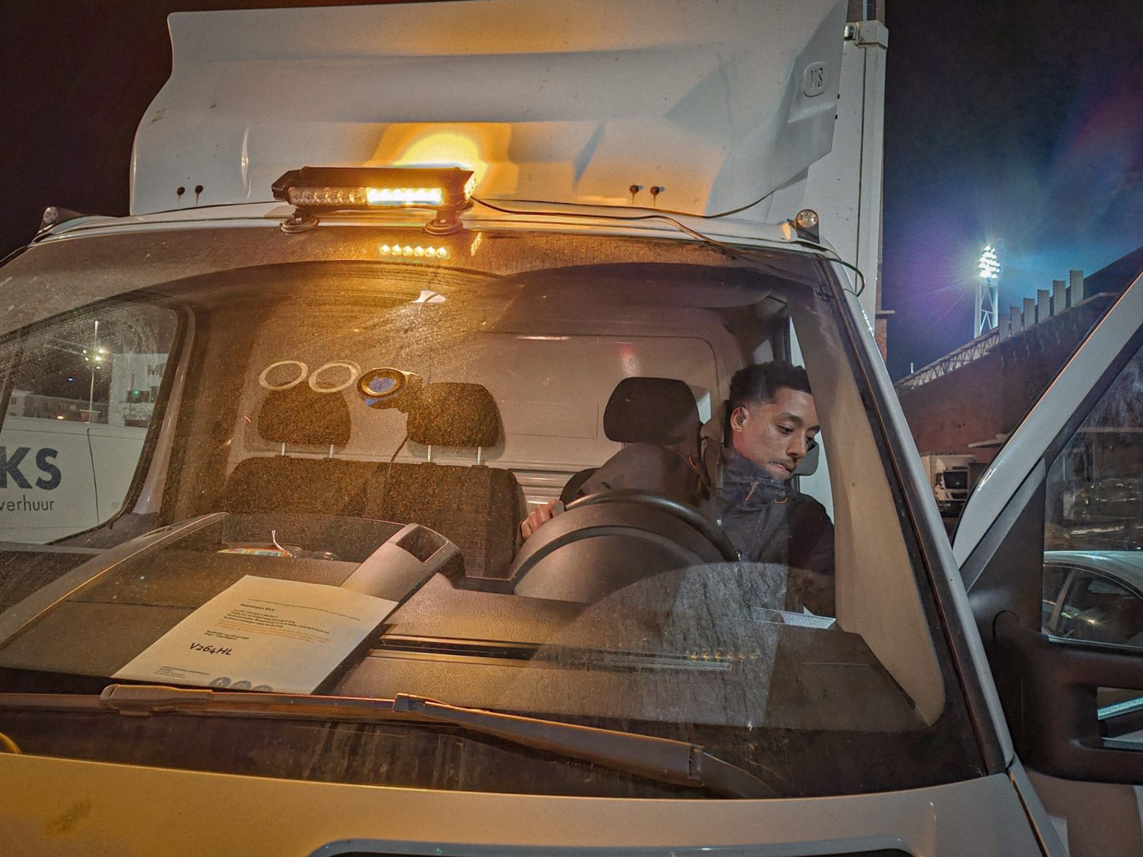 Crew van with beacon light at night on set