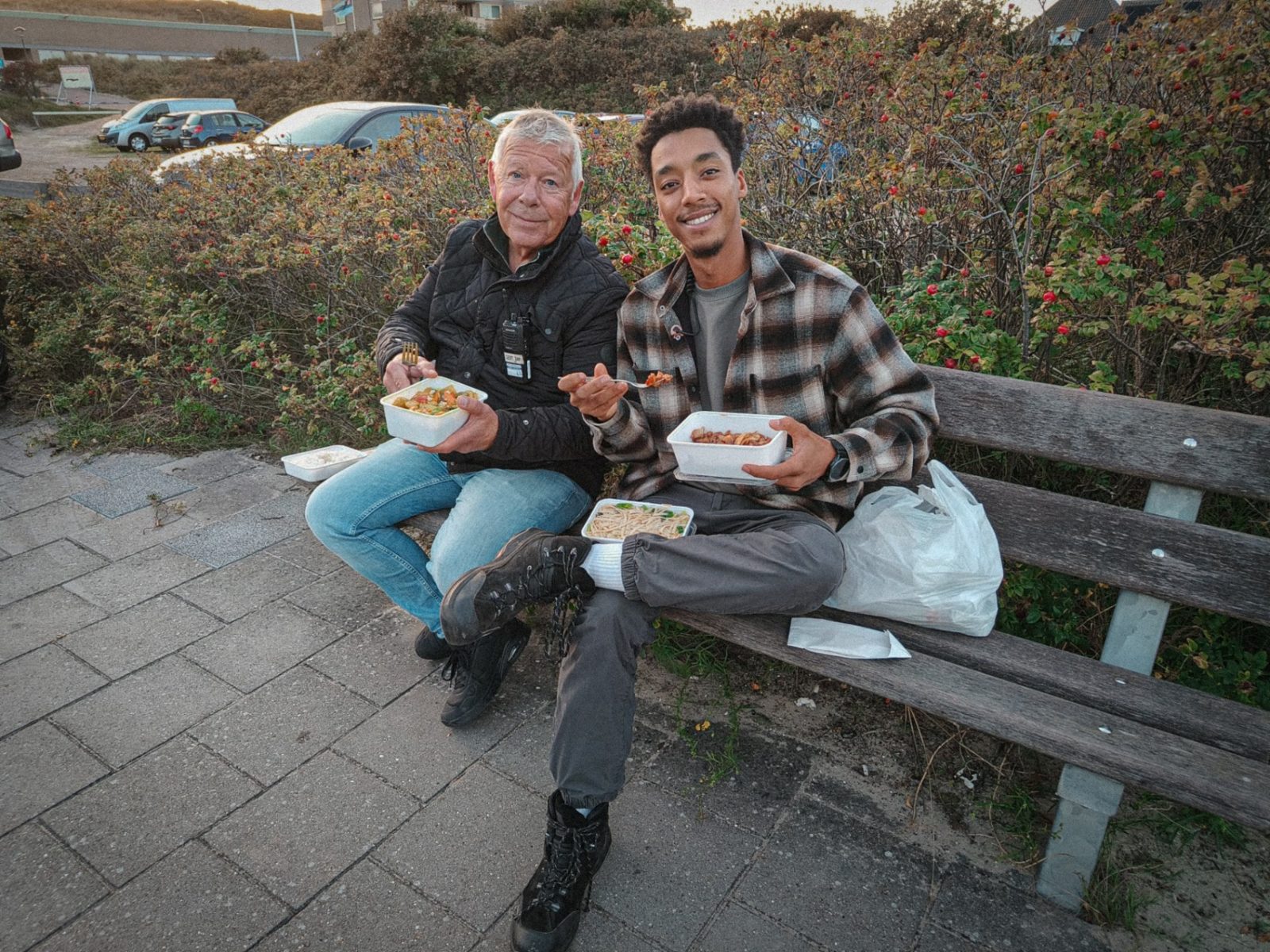 Issam having lunch on a bench with a colleague